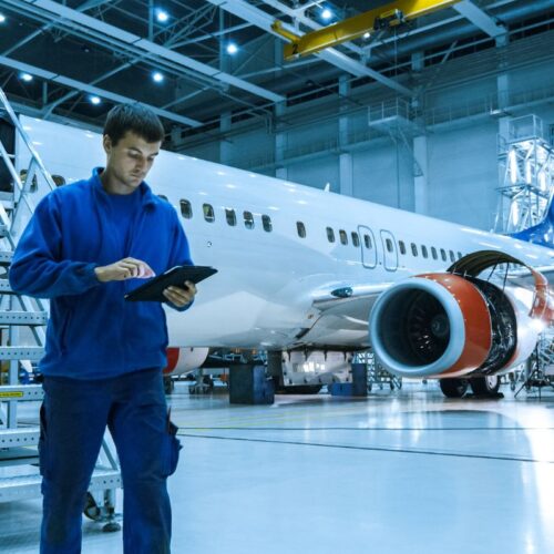 person on clipboard next to aircraft